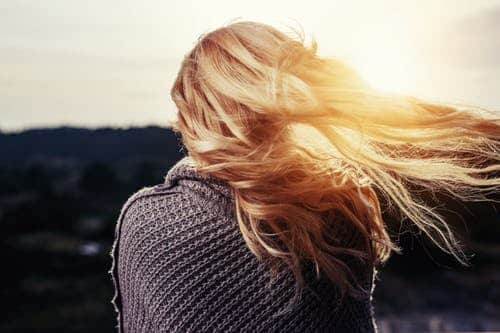 Image of a girl outdoors with her hair shining in the sun