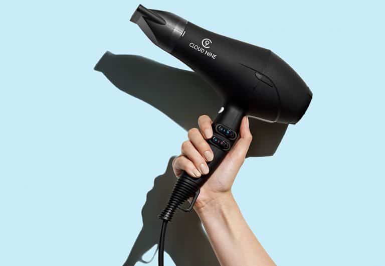 Image of someone holding the black Cloud Nine Airshot hair dryer